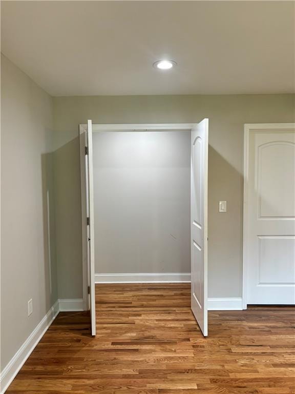 interior space featuring recessed lighting, wood finished floors, and baseboards