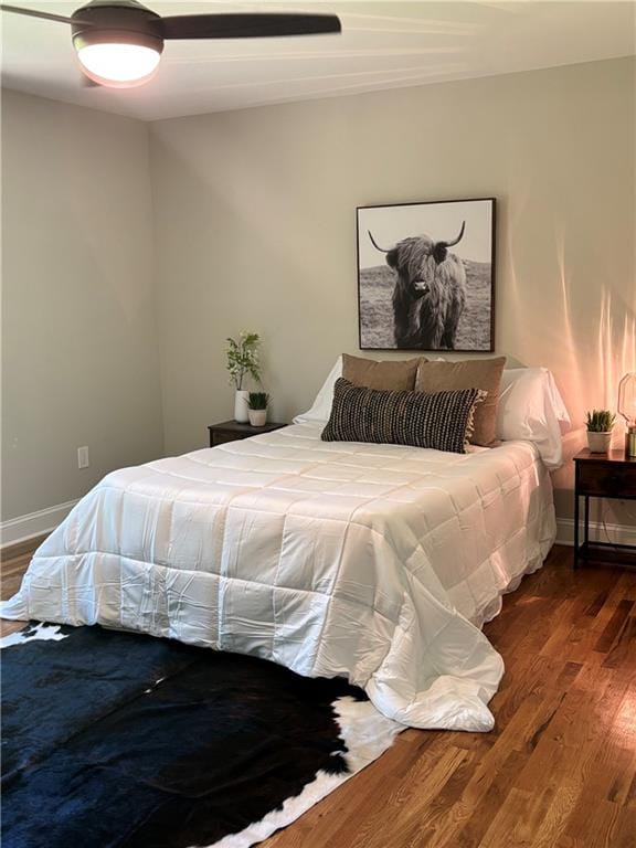 bedroom featuring dark wood-type flooring and ceiling fan