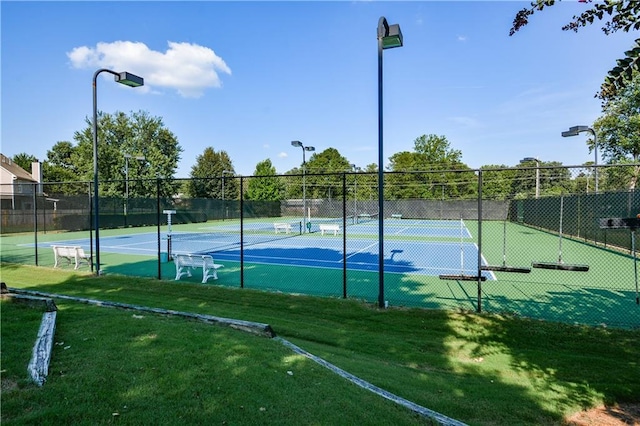 view of sport court featuring a yard