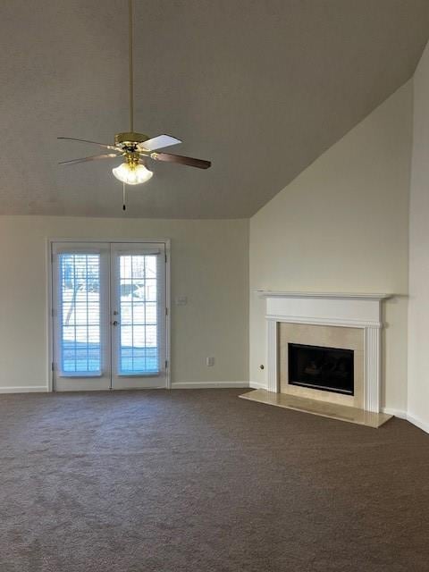 unfurnished living room featuring dark colored carpet, ceiling fan, french doors, and vaulted ceiling