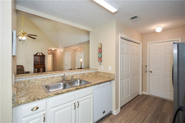 kitchen with white dishwasher, ceiling fan, sink, white cabinets, and stainless steel refrigerator