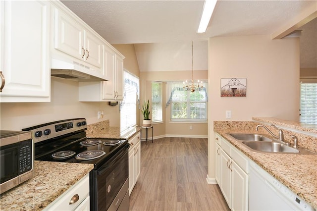 kitchen featuring hanging light fixtures, sink, light wood-type flooring, appliances with stainless steel finishes, and white cabinetry