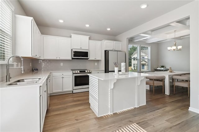 4172 Cedar Commons Way, Conley, GA 30288 - kitchen featuring appliances with stainless steel finishes, a sink, recessed lighting, decorative backsplash, and a center island