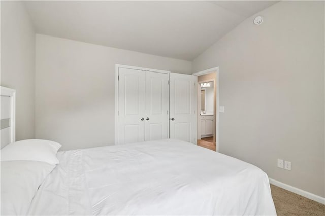 4172 Cedar Commons Way, Conley, GA 30288 - bedroom with light colored carpet, vaulted ceiling, a closet, and baseboards