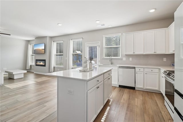 4172 Cedar Commons Way, Conley, GA 30288 - kitchen with white dishwasher, a sink, open floor plan, light countertops, and recessed lighting