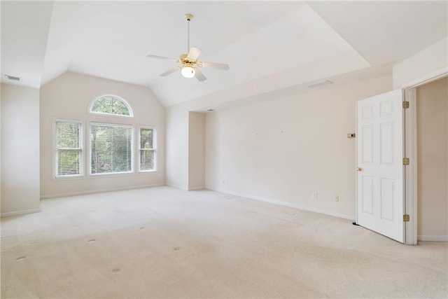 carpeted spare room featuring ceiling fan and vaulted ceiling