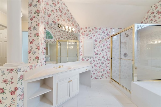 bathroom featuring vanity, tile patterned floors, vaulted ceiling, a shower with shower door, and decorative columns