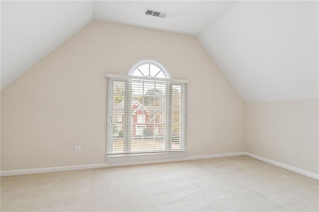 bonus room featuring lofted ceiling and light carpet