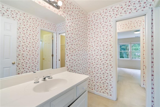 bathroom with crown molding and vanity