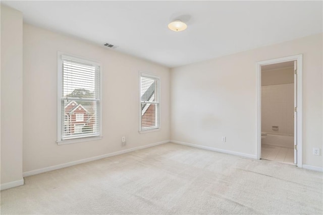 unfurnished room with light colored carpet