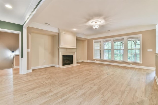 6714 Amherst Dr, Hoschton, GA 30548 - unfurnished living room featuring ornamental molding, a glass covered fireplace, light wood finished floors, and baseboards