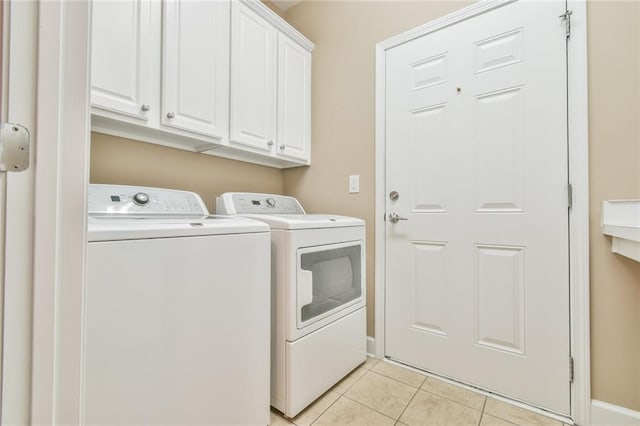 6714 Amherst Dr, Hoschton, GA 30548 - laundry room with washing machine and clothes dryer, cabinet space, light tile patterned flooring, and baseboards