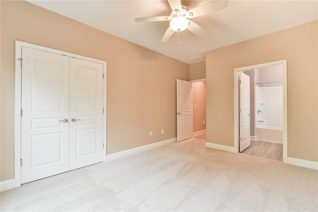 6714 Amherst Dr, Hoschton, GA 30548 - unfurnished bedroom featuring light carpet, a closet, baseboards, ensuite bath, and ceiling fan