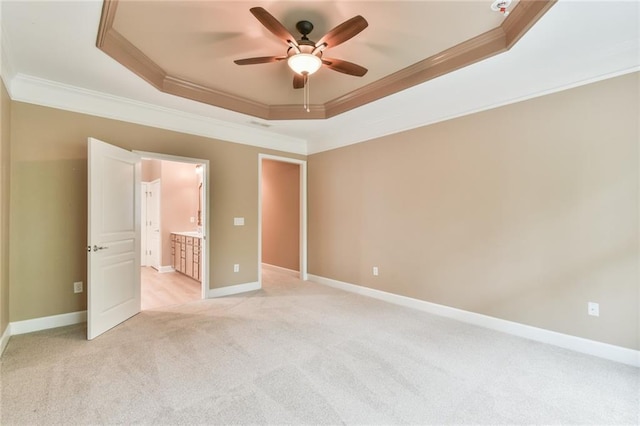 6714 Amherst Dr, Hoschton, GA 30548 - unfurnished bedroom with a tray ceiling, ornamental molding, light colored carpet, baseboards, and ensuite bath