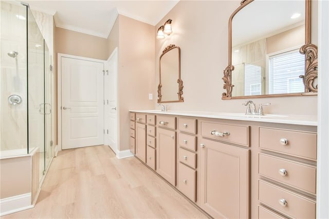 6714 Amherst Dr, Hoschton, GA 30548 - bathroom with crown molding, a shower stall, wood finished floors, double vanity, and baseboards
