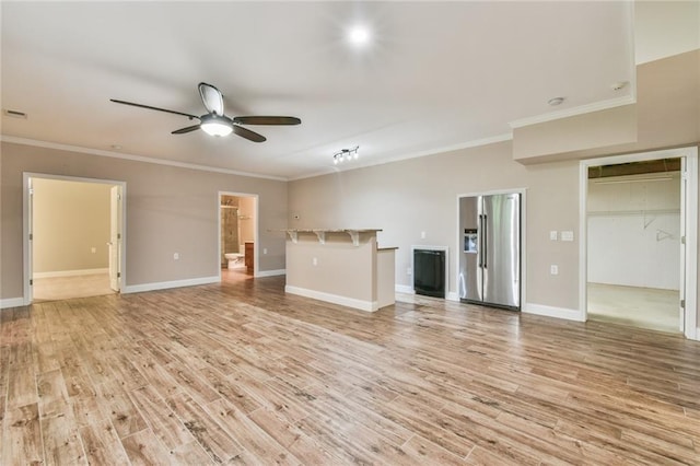 6714 Amherst Dr, Hoschton, GA 30548 - unfurnished living room with ceiling fan, light wood-type flooring, crown molding, and baseboards