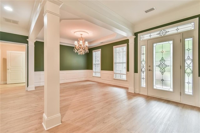 6714 Amherst Dr, Hoschton, GA 30548 - entrance foyer with decorative columns, plenty of natural light, light wood-style floors, a wainscoted wall, and ornamental molding