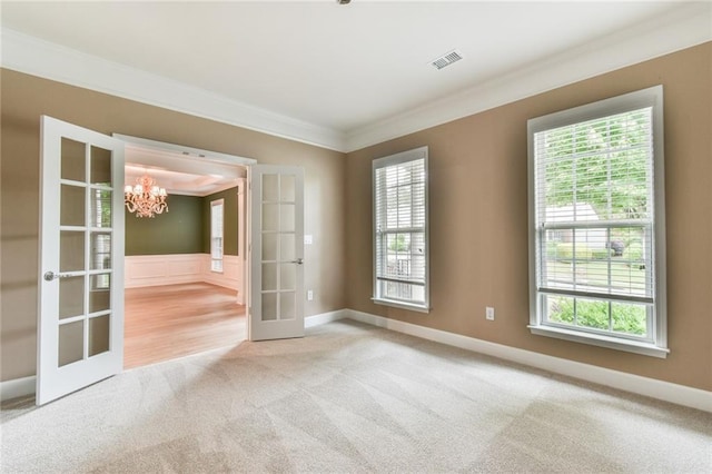 6714 Amherst Dr, Hoschton, GA 30548 - unfurnished room with french doors, carpet flooring, crown molding, a chandelier, and baseboards