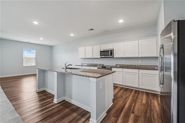 31 Mccall Way, Monroe, GA 30655 - kitchen featuring stainless steel appliances, dark wood-type flooring, dark stone counters, white cabinets, and recessed lighting