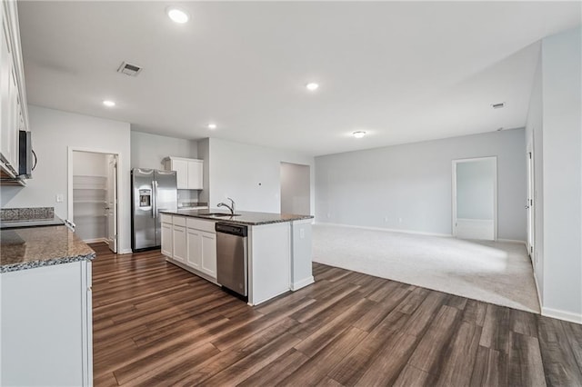 31 Mccall Way, Monroe, GA 30655 - kitchen with appliances with stainless steel finishes, dark wood-style flooring, white cabinets, open floor plan, and a center island with sink