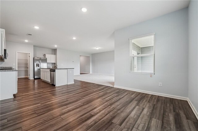 31 Mccall Way, Monroe, GA 30655 - unfurnished living room featuring dark wood-style floors and recessed lighting