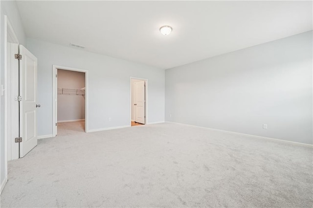 31 Mccall Way, Monroe, GA 30655 - unfurnished bedroom featuring light colored carpet, a walk in closet, and a closet