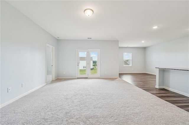 31 Mccall Way, Monroe, GA 30655 - unfurnished living room featuring carpet floors, wood finished floors, and recessed lighting