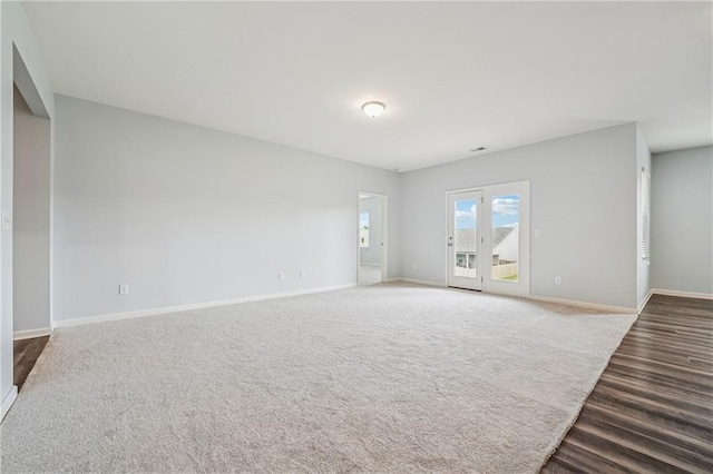 31 Mccall Way, Monroe, GA 30655 - unfurnished living room with baseboards and dark wood-style floors