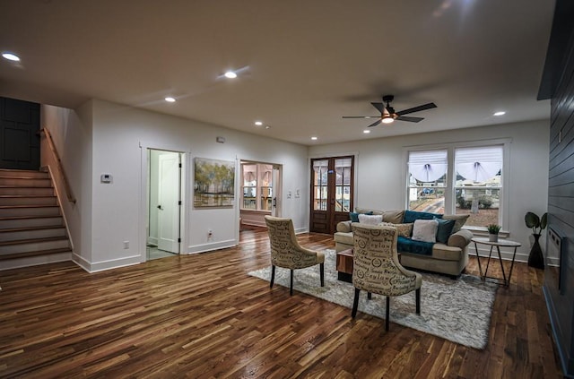 living room with dark hardwood / wood-style floors and ceiling fan