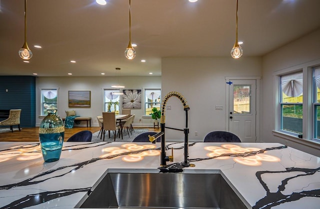 kitchen with pendant lighting, sink, and a wealth of natural light