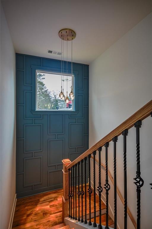 stairs with hardwood / wood-style flooring