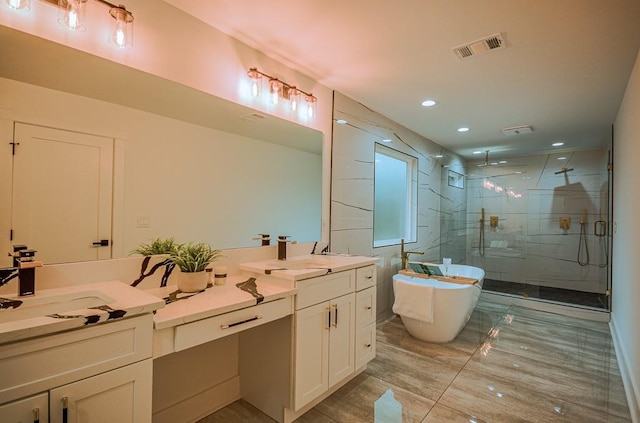 bathroom with shower with separate bathtub and vanity