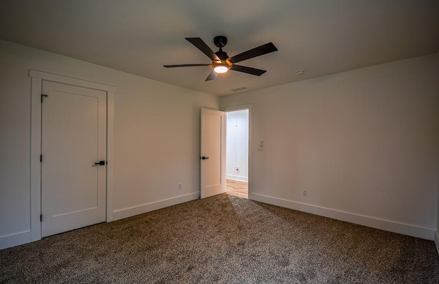 unfurnished bedroom featuring ceiling fan and carpet