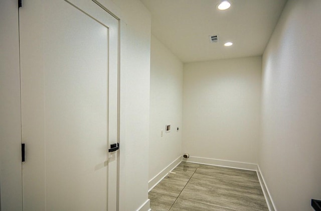 laundry area featuring washer hookup, hookup for an electric dryer, and light hardwood / wood-style flooring