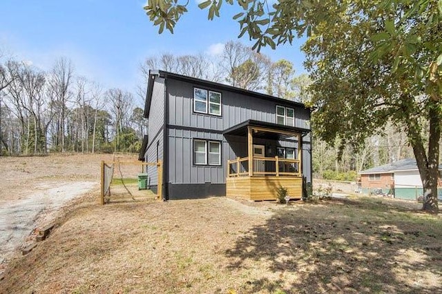 view of front of home featuring board and batten siding and driveway