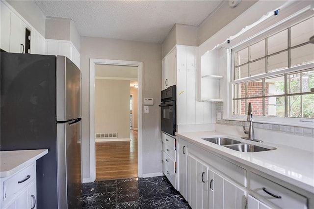 1753 Dodson Dr SW, Atlanta, GA 30311 - kitchen featuring freestanding refrigerator, visible vents, marble finish floor, a sink, and oven