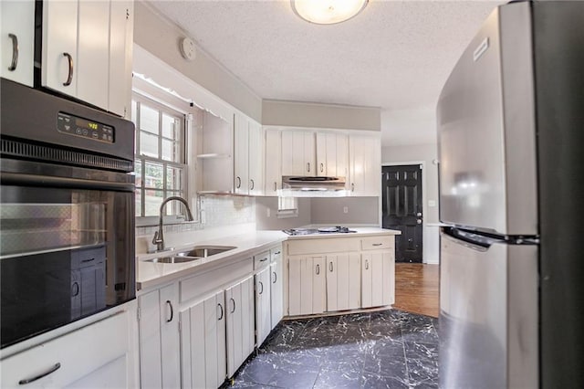 1753 Dodson Dr SW, Atlanta, GA 30311 - kitchen featuring light countertops, freestanding refrigerator, oven, a sink, and stovetop