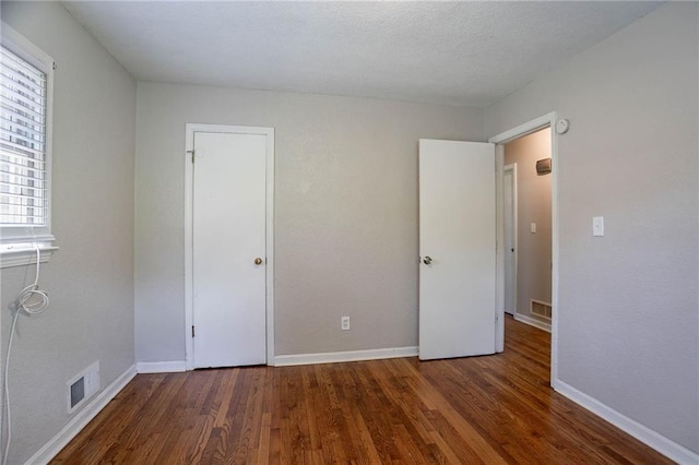 1753 Dodson Dr SW, Atlanta, GA 30311 - unfurnished bedroom with visible vents, baseboards, and wood finished floors