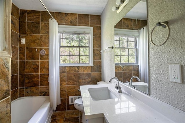 1753 Dodson Dr SW, Atlanta, GA 30311 - bathroom featuring visible vents, tile walls, toilet, and a healthy amount of sunlight