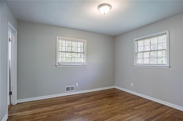 1753 Dodson Dr SW, Atlanta, GA 30311 - empty room featuring dark wood-type flooring, visible vents, and a wealth of natural light