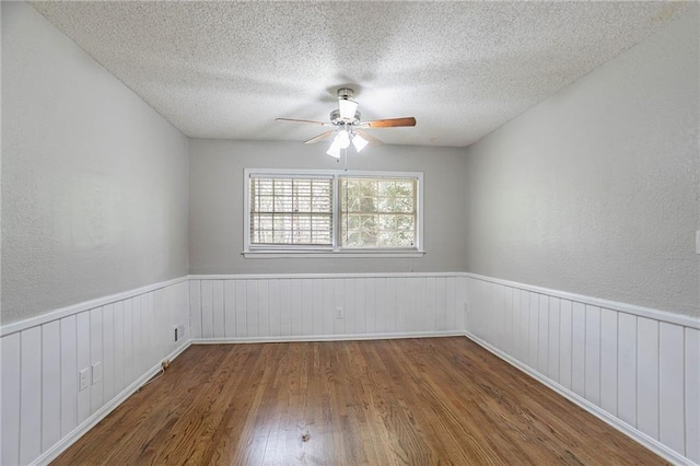 1753 Dodson Dr SW, Atlanta, GA 30311 - empty room featuring a wainscoted wall, a ceiling fan, wood finished floors, and a textured ceiling