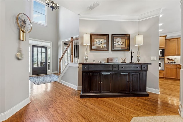 4492 Arbor Crest Ct, Suwanee, GA 30024 - entryway with light wood-style floors, stairway, crown molding, and a chandelier