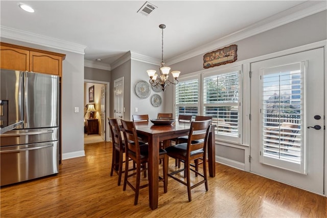 4492 Arbor Crest Ct, Suwanee, GA 30024 - dining area featuring a chandelier, light wood-style flooring, ornamental molding, and recessed lighting