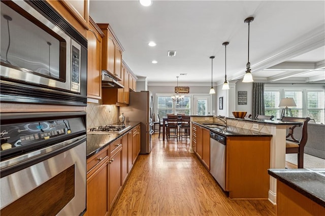 4492 Arbor Crest Ct, Suwanee, GA 30024 - kitchen with appliances with stainless steel finishes, brown cabinets, light wood-style floors, recessed lighting, and ornamental molding