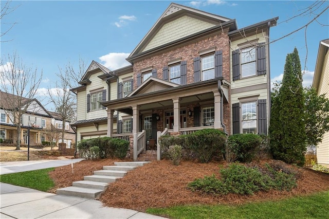 4492 Arbor Crest Ct, Suwanee, GA 30024 - view of front of home featuring covered porch, a garage, driveway, and brick siding