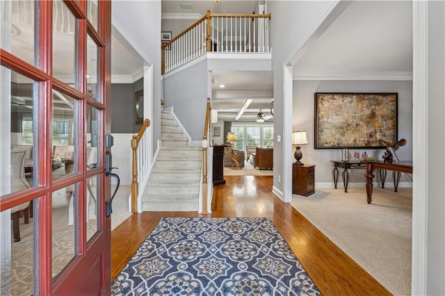 4492 Arbor Crest Ct, Suwanee, GA 30024 - entryway featuring a ceiling fan, stairs, ornamental molding, wood finished floors, and a high ceiling