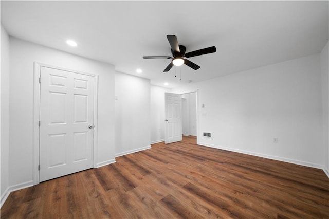 unfurnished bedroom with ceiling fan and dark hardwood / wood-style floors