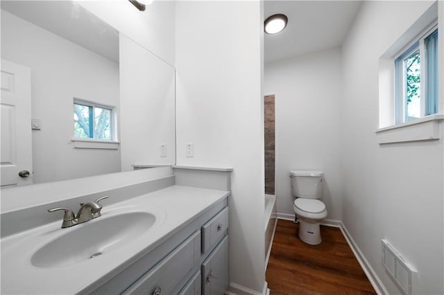 full bathroom with toilet, shower / bath combination, vanity, and wood-type flooring