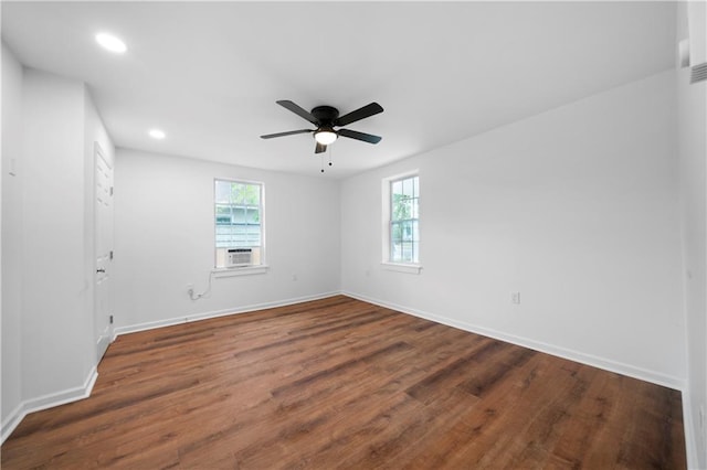 spare room featuring cooling unit, dark hardwood / wood-style floors, and ceiling fan