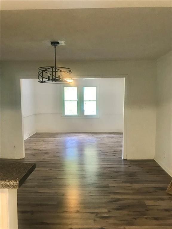 unfurnished dining area with dark hardwood / wood-style floors